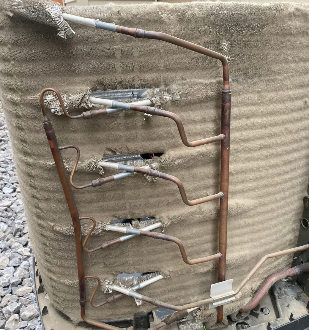 Plugged outdoor air conditioner condenser coil before cleaning